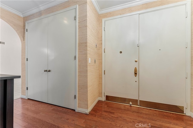 foyer entrance featuring wood-type flooring and ornamental molding