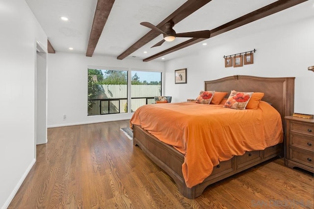 bedroom featuring dark wood-type flooring, beamed ceiling, and ceiling fan