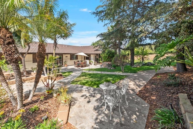 exterior space featuring a lawn and a patio area