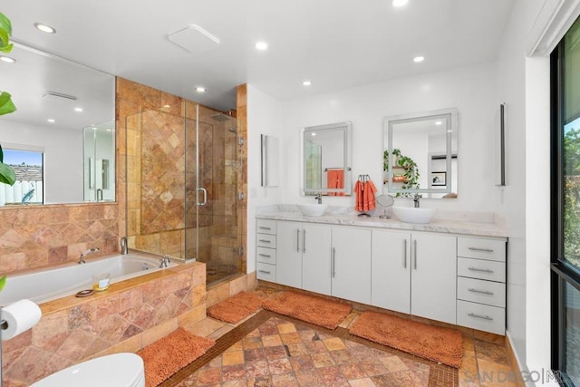 bathroom featuring vanity, a wealth of natural light, and independent shower and bath