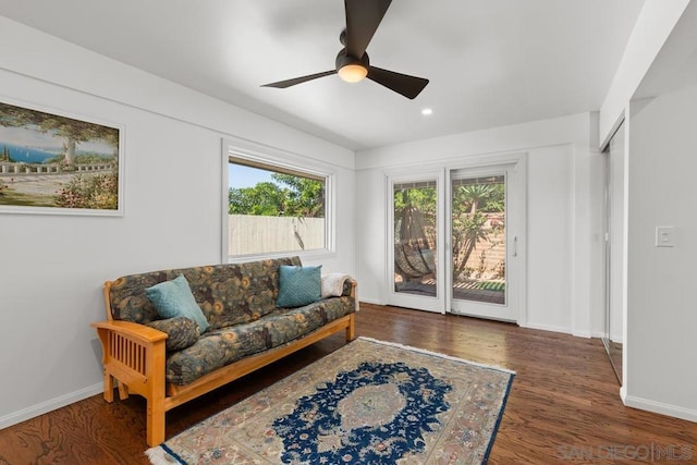 living room with ceiling fan and dark hardwood / wood-style floors