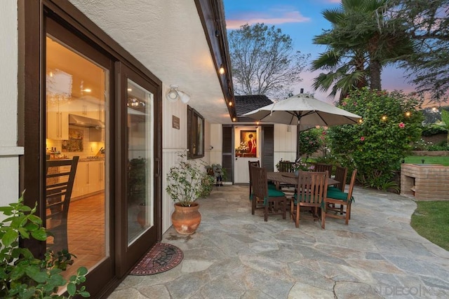 view of patio terrace at dusk