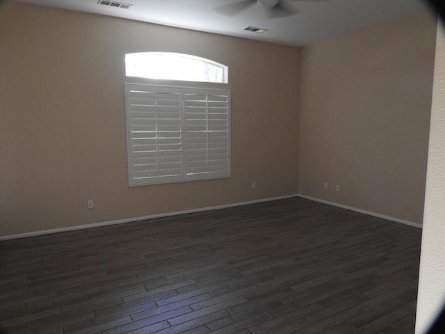 unfurnished room featuring ceiling fan and dark hardwood / wood-style flooring