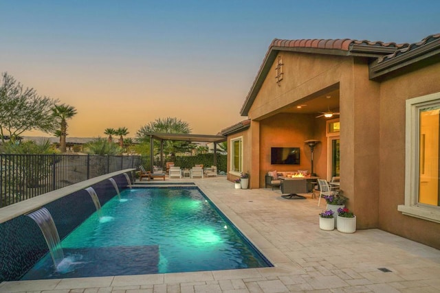 view of pool featuring an outdoor living space with a fireplace, a patio area, and pool water feature