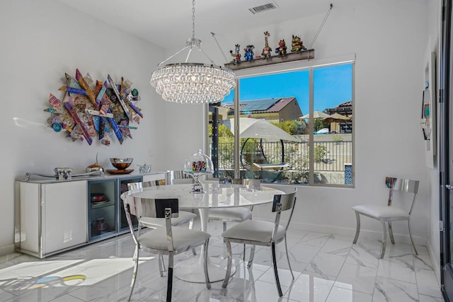 dining area with an inviting chandelier