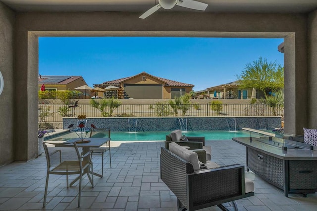 view of swimming pool with a patio area, pool water feature, and ceiling fan