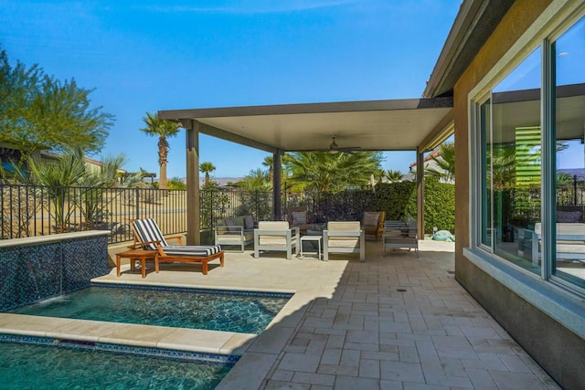 view of pool with outdoor lounge area, ceiling fan, pool water feature, and a patio