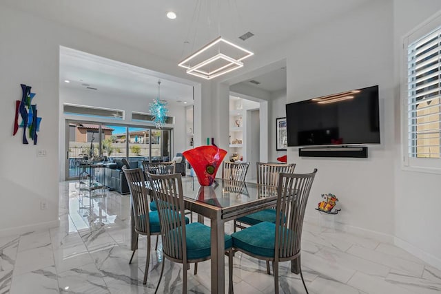 dining area featuring an inviting chandelier and a wealth of natural light