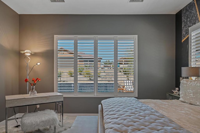 bedroom featuring multiple windows