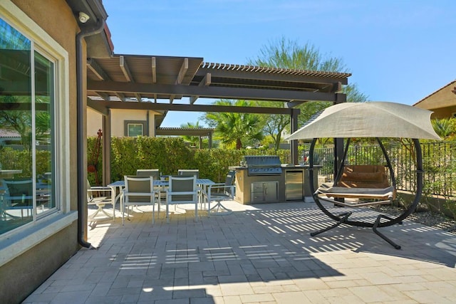 view of patio with a pergola, grilling area, and exterior kitchen