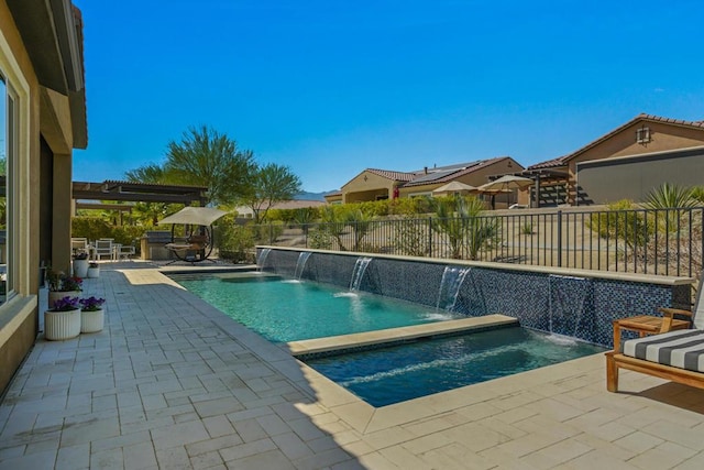 view of swimming pool with pool water feature, a patio area, a pergola, and an in ground hot tub