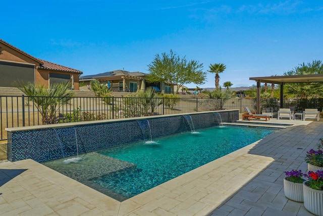 view of swimming pool with pool water feature and a patio