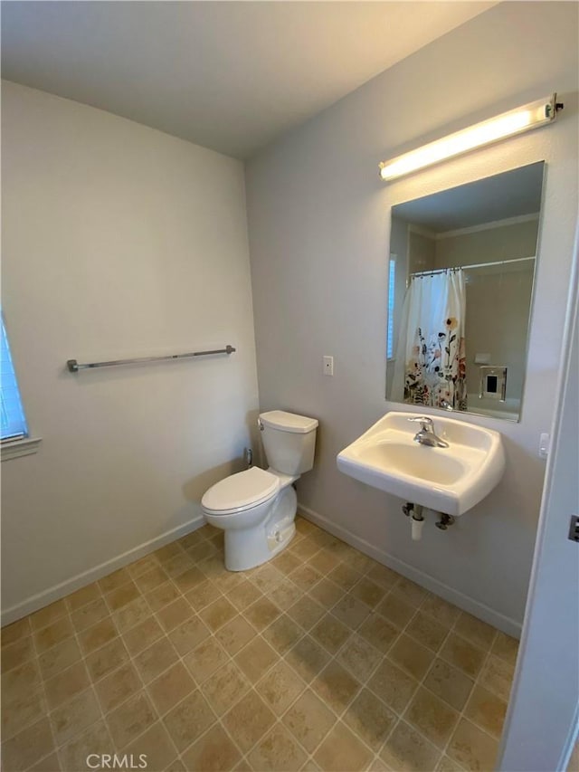 bathroom with sink, toilet, and walk in shower