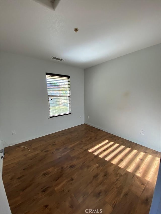 unfurnished room featuring dark hardwood / wood-style flooring