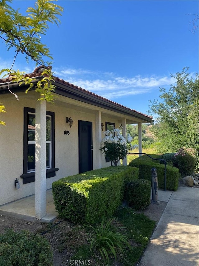 605 N Ferrocarril, Atascadero, CA 93422 - doorway to property featuring stucco siding, covered porch, and a tile roof