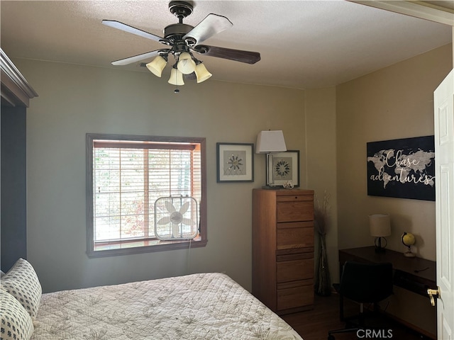 bedroom featuring ceiling fan and dark hardwood / wood-style floors