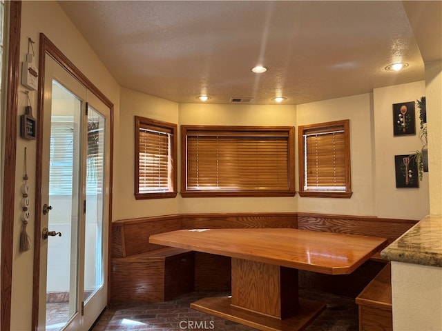 unfurnished dining area with a textured ceiling