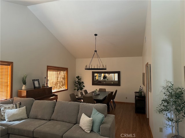 living room featuring high vaulted ceiling and dark hardwood / wood-style flooring