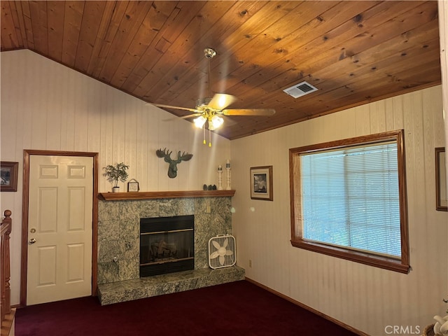 unfurnished living room featuring lofted ceiling, ceiling fan, wood ceiling, a premium fireplace, and carpet flooring