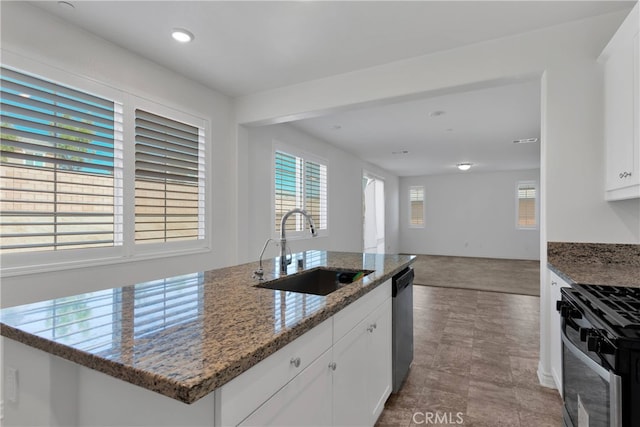 kitchen featuring stainless steel appliances, white cabinets, sink, and stone countertops