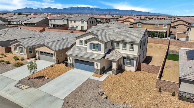 view of front of property featuring a mountain view and a garage