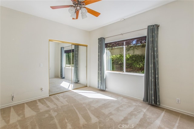 empty room with light carpet and ceiling fan