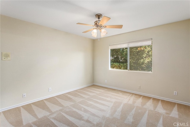 unfurnished room with ceiling fan and light colored carpet