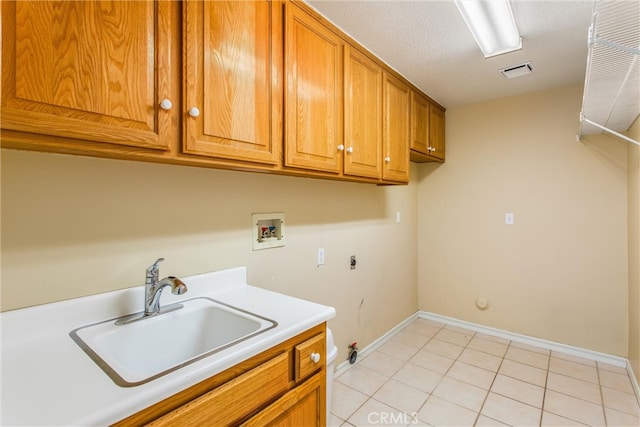 washroom featuring washer hookup, cabinets, hookup for a gas dryer, hookup for an electric dryer, and sink