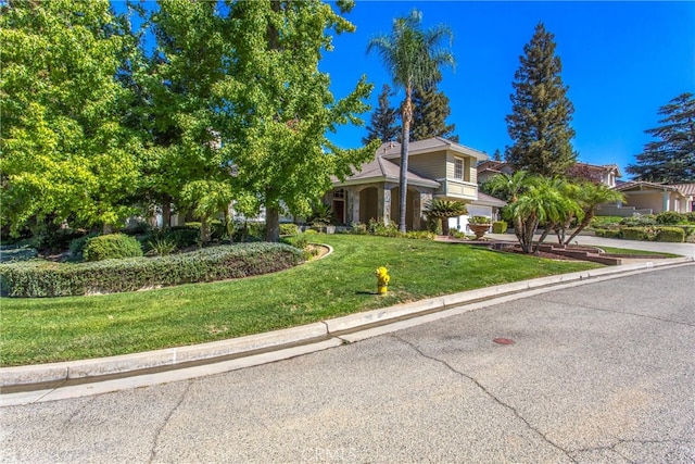 view of front of house with a front yard and a garage