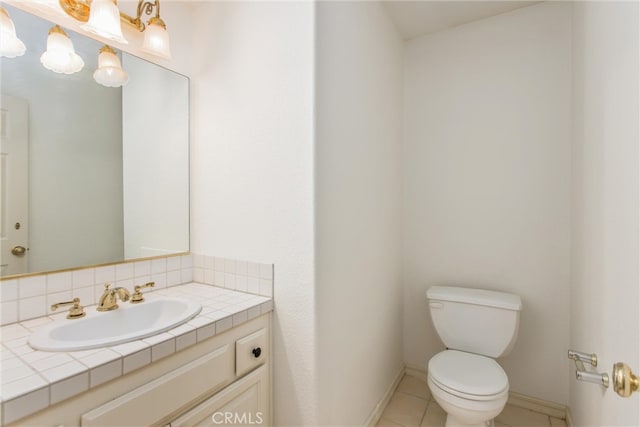 bathroom featuring tile patterned flooring, vanity, and toilet