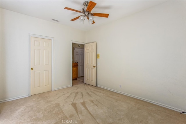 unfurnished bedroom featuring ceiling fan and light colored carpet