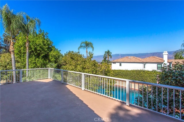 exterior space featuring a mountain view and a balcony