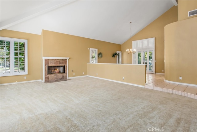 unfurnished living room with light carpet, plenty of natural light, and high vaulted ceiling