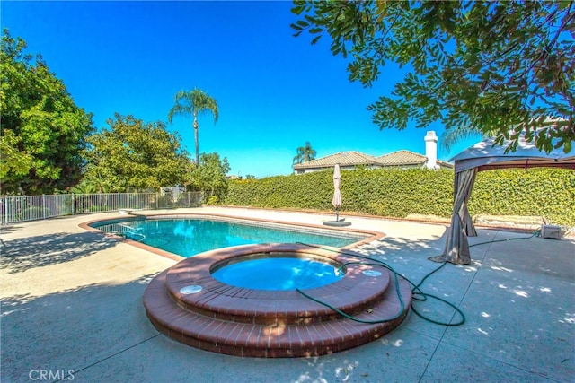 view of swimming pool with a gazebo, a patio, a diving board, and an in ground hot tub