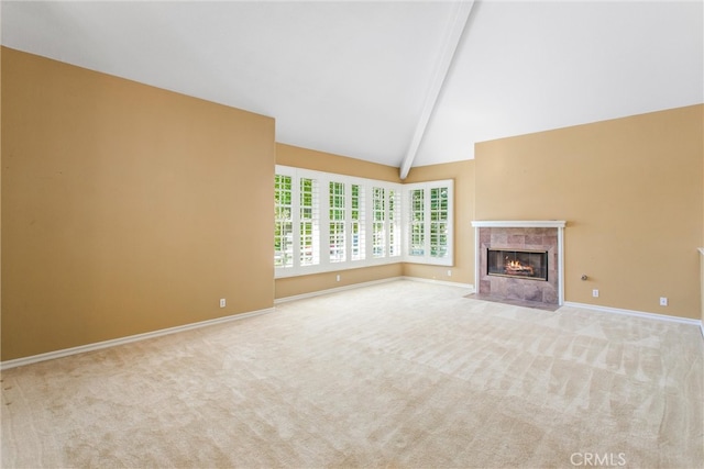 unfurnished living room featuring light colored carpet, a fireplace, and lofted ceiling with beams