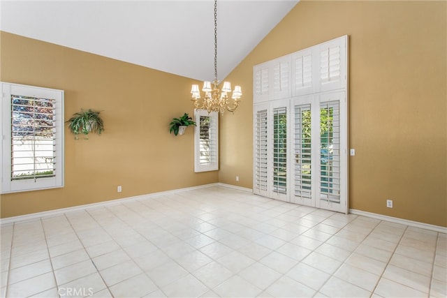 spare room featuring high vaulted ceiling, a chandelier, and light tile patterned floors