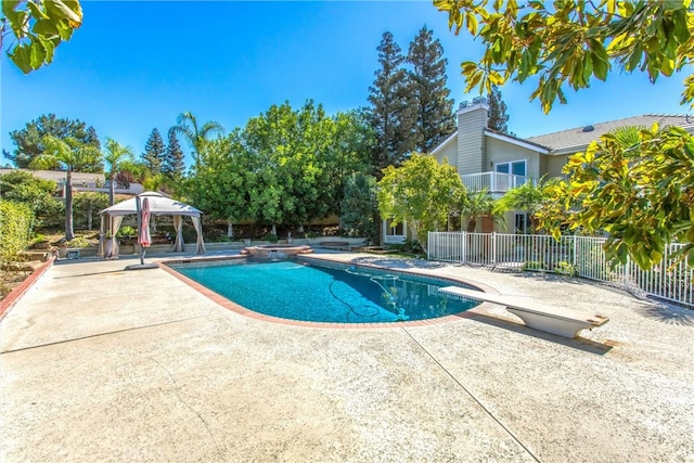 view of pool with a gazebo, a patio, and a diving board