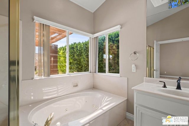 bathroom featuring independent shower and bath, vanity, and a healthy amount of sunlight