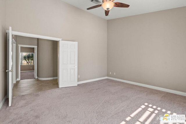 unfurnished bedroom with light colored carpet and ceiling fan