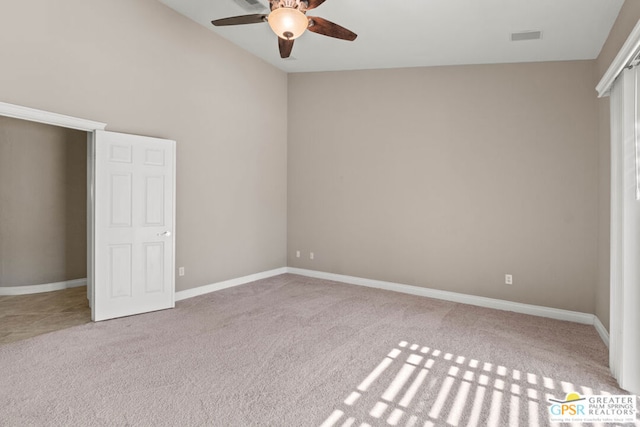 unfurnished bedroom with light carpet, ceiling fan, and lofted ceiling