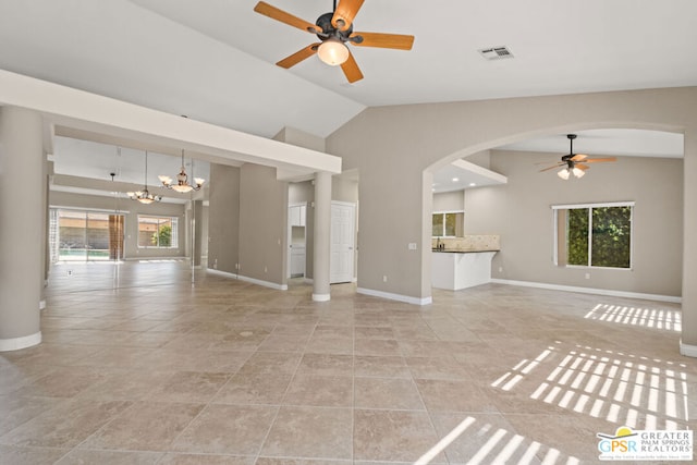 unfurnished living room with lofted ceiling, light tile patterned floors, and a wealth of natural light