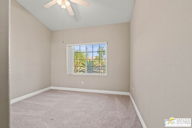 carpeted spare room featuring lofted ceiling and ceiling fan