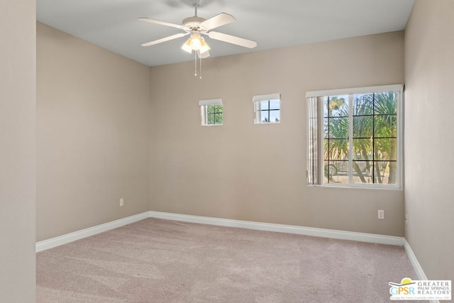 empty room with ceiling fan and light colored carpet