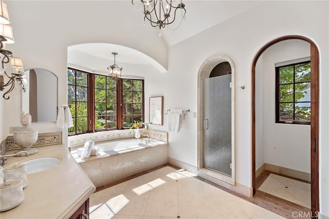 bathroom with vanity, tile patterned flooring, shower with separate bathtub, a chandelier, and lofted ceiling