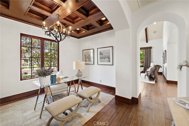 home office featuring beam ceiling, coffered ceiling, a notable chandelier, crown molding, and hardwood / wood-style flooring