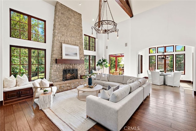 living room with beam ceiling, a fireplace, a towering ceiling, and dark hardwood / wood-style floors