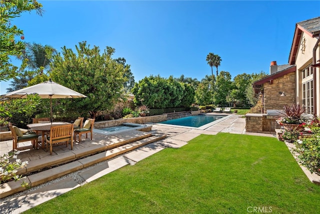 view of pool with a yard, a patio, and a hot tub