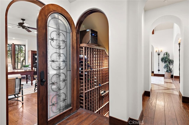 wine area featuring hardwood / wood-style flooring and ceiling fan