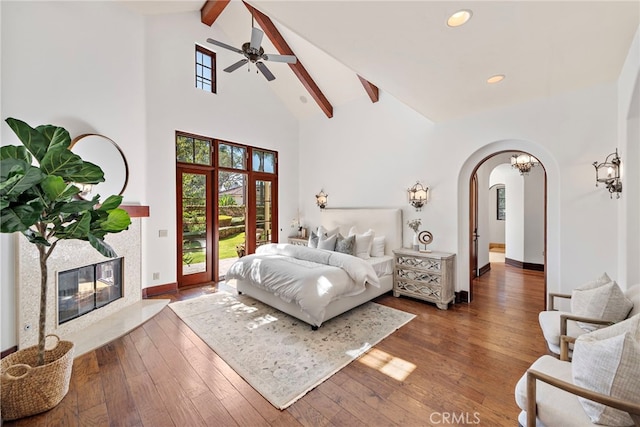 bedroom with beamed ceiling, dark hardwood / wood-style flooring, ceiling fan, and access to exterior