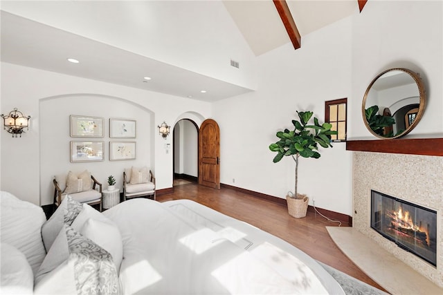 bedroom with beam ceiling, dark hardwood / wood-style floors, and high vaulted ceiling